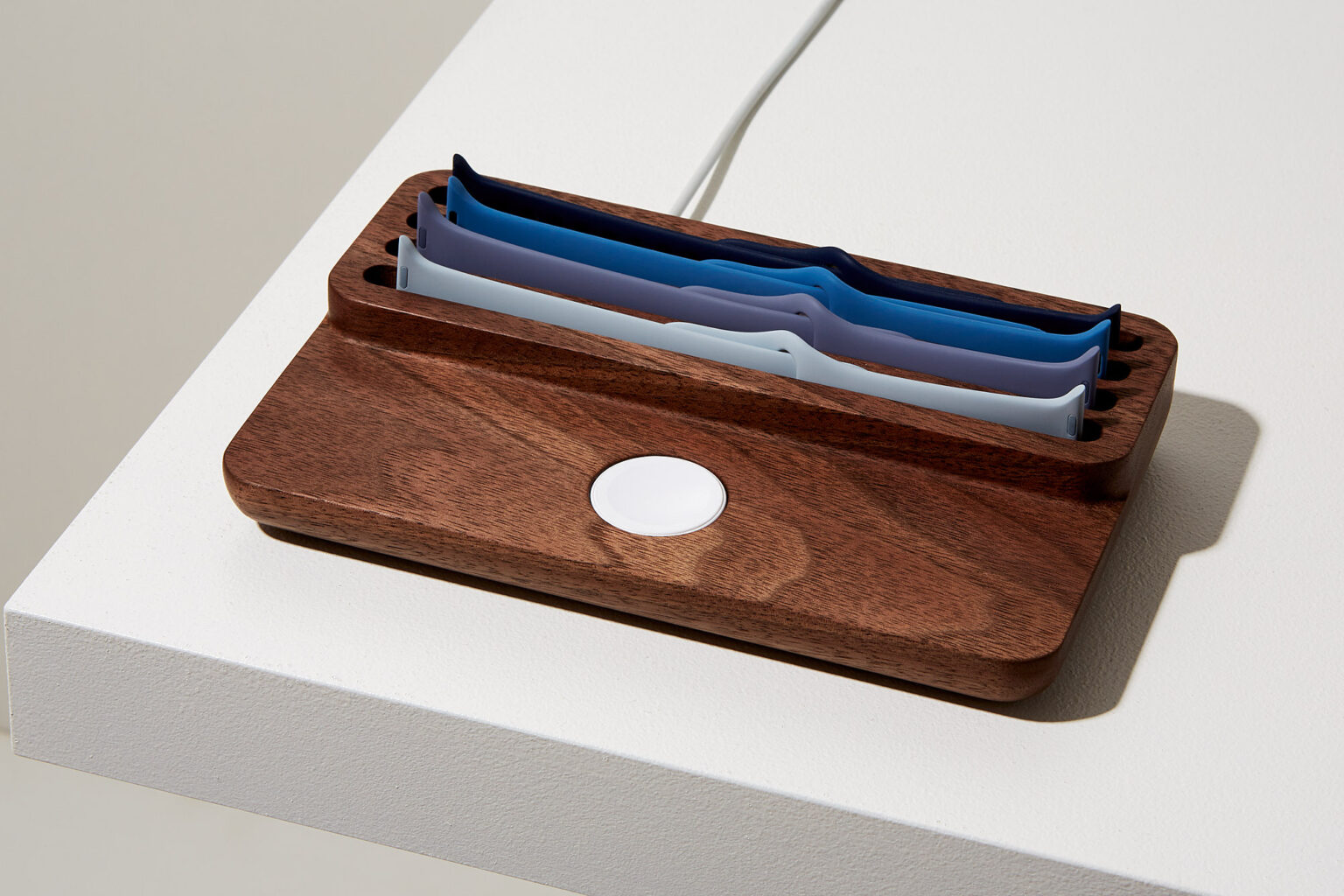 Anden Watch Valet in walnut with spare watch straps tucked into the curved tray