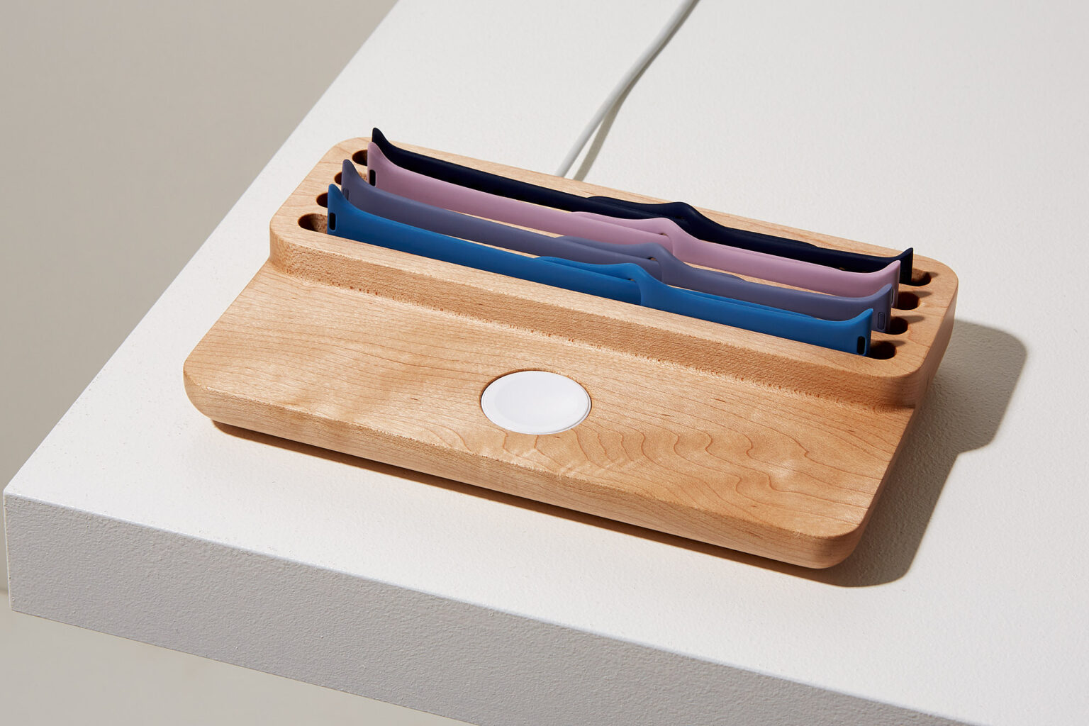 Anden Watch Valet in light oak with spare straps and the charger opening visible