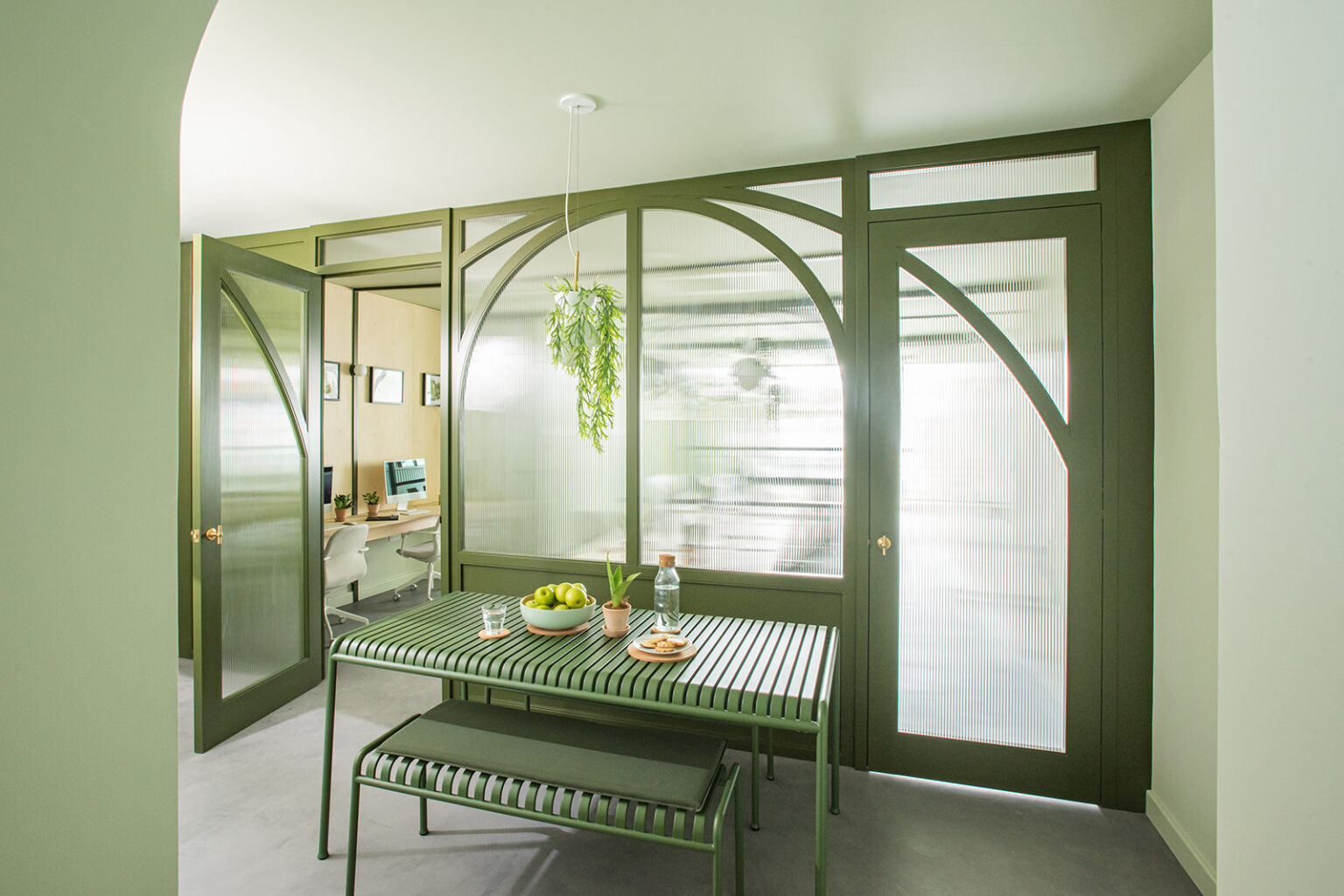 Stow Brothers South Woodford meeting room framed by green arched partitions