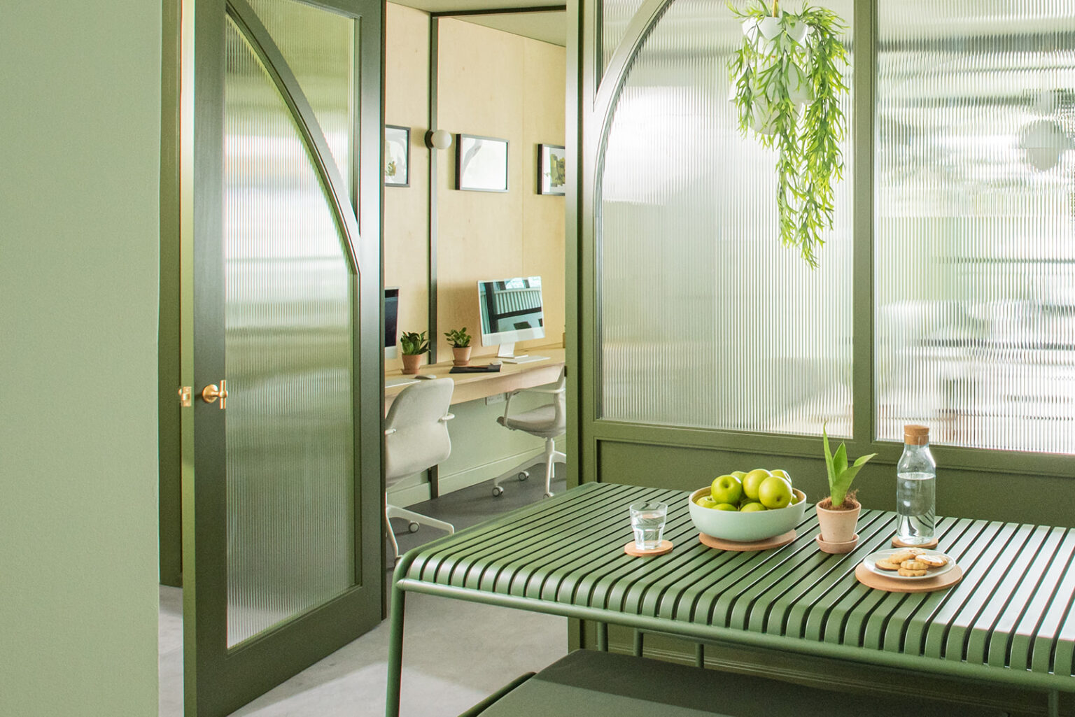 Green bespoke meeting booth with arched frame in the Stow Brothers South Woodford office