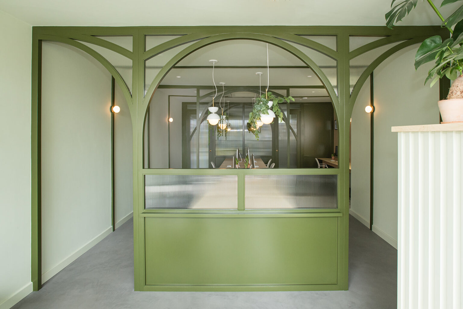 Green arched reception area in the Stow Brothers South Woodford office